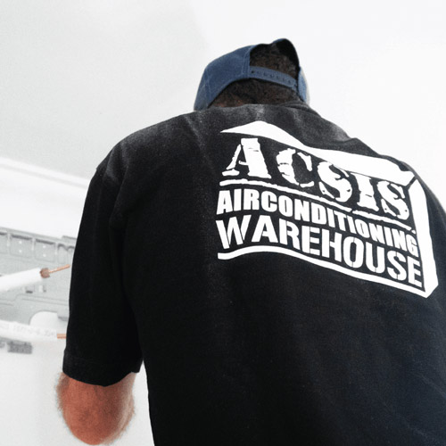 A staff member at leading Airconditioning supplier and installer; Acsis Airconditioning warehouse installing a brand new Daikin unit.
